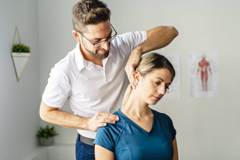 A Modern rehabilitation physiotherapy man at work with woman client